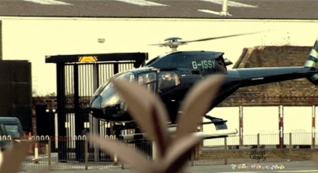 A black helicopter taking off